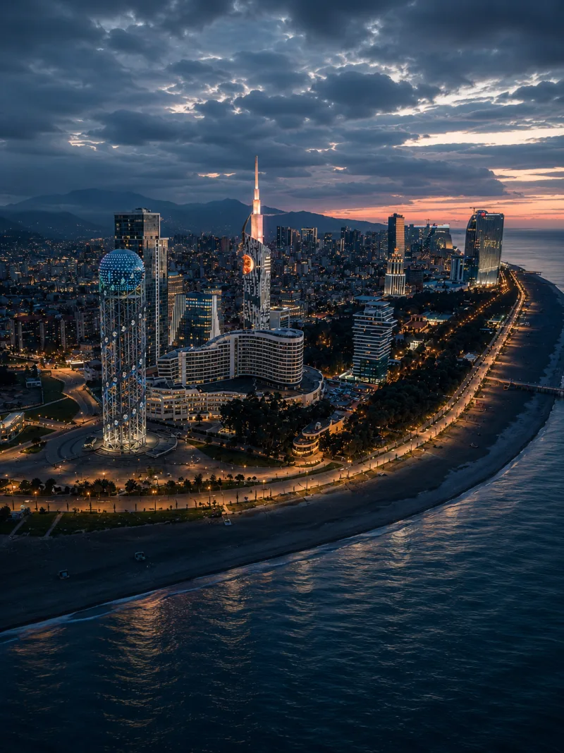 Batumi, Georgia — aerial night view of the Black Sea waterfront with the Alphabet Tower