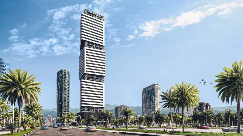 The tower above a palm-lined avenue — Cube Metropol, Batumi