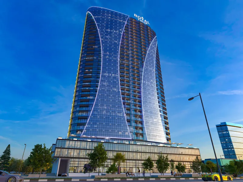 The curved facade lit in the evening — Ovale Metropol, Batumi