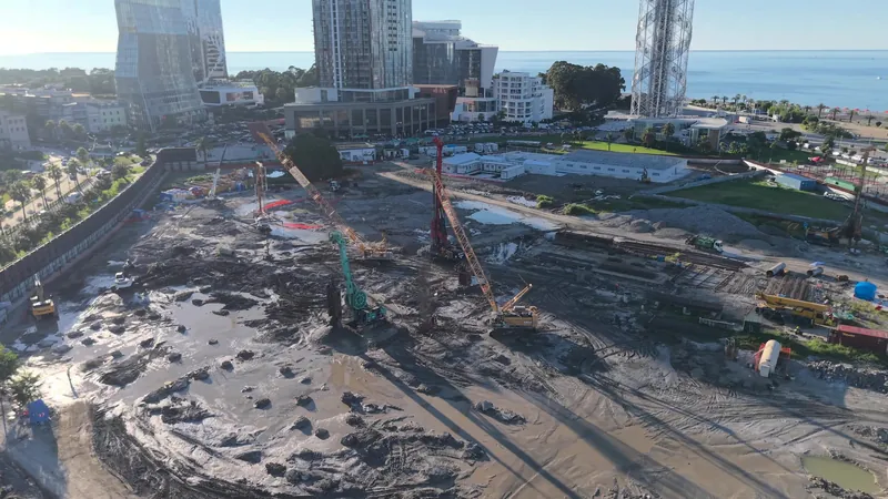 Construction site toward the city, drone view — Silk Towers, Batumi
